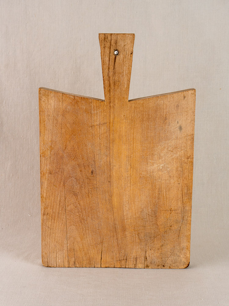 Antique French hardwood cutting board in traditional Provencal style with visible grain and gentle wear.
