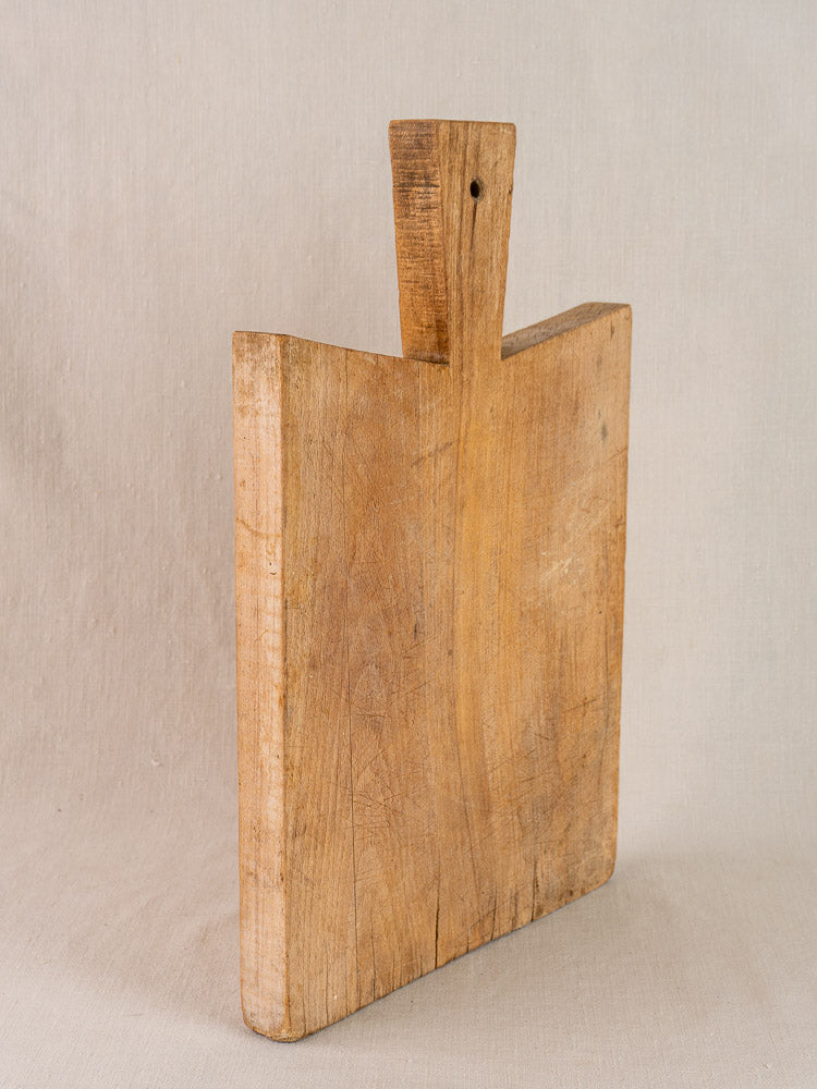Antique French hardwood cutting board in Provencal style with wide handle and hole, rectangular and thick.