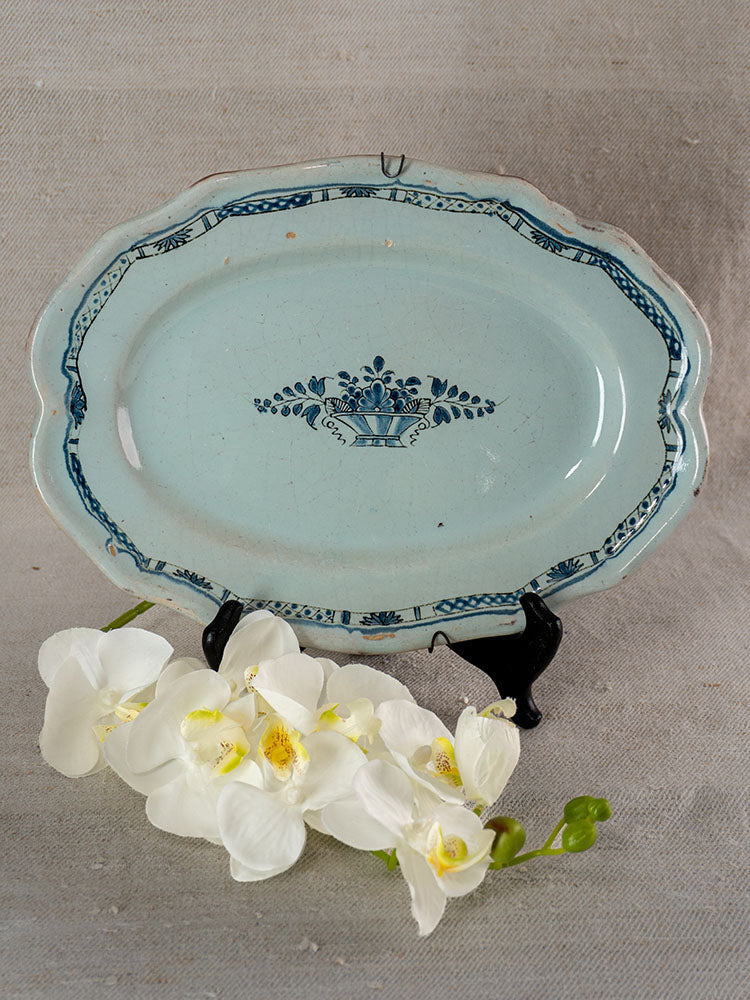 19th century French faience platter, Rouen Cul Noir, blue floral design, on black stand with orchids.