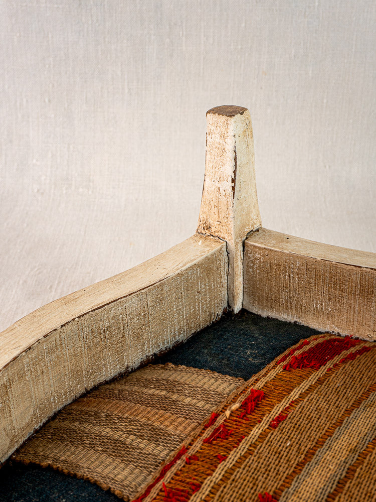 Antique French footstool with painted Louis XV frame and hemp torchon upholstery in earth tones.