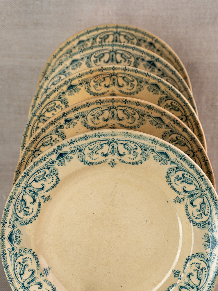Set of six antique French "Caïffa Guirlande" faience dinner plates with ornate blue floral scroll borders on beige.