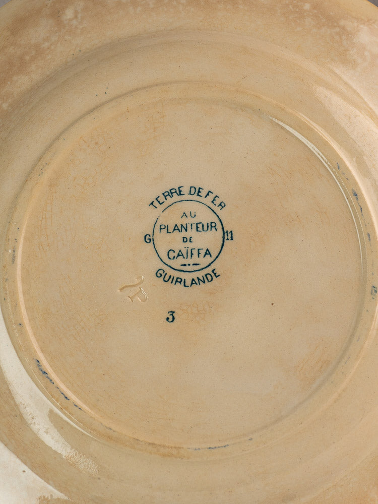 Back of Antique French Terre de Fer Faience Caïffa Guirlande plate with circular maker's mark and impressed numbers.