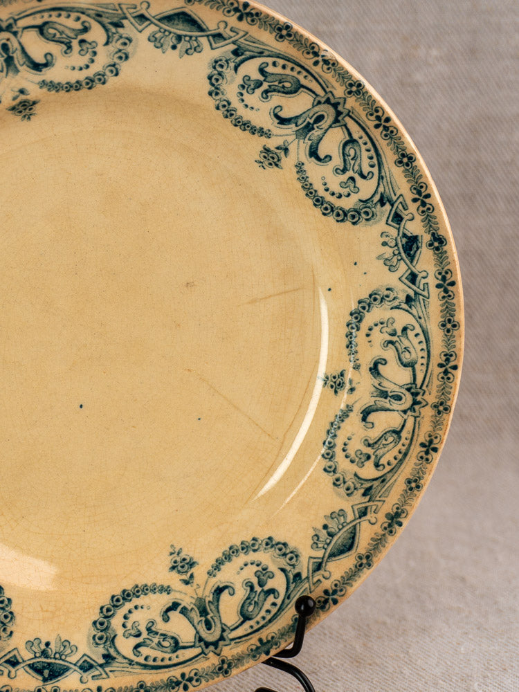 Antique French Caïffa Guirlande Terre de Fer dinner plate with faded cream glaze, green border, and vintage age marks.