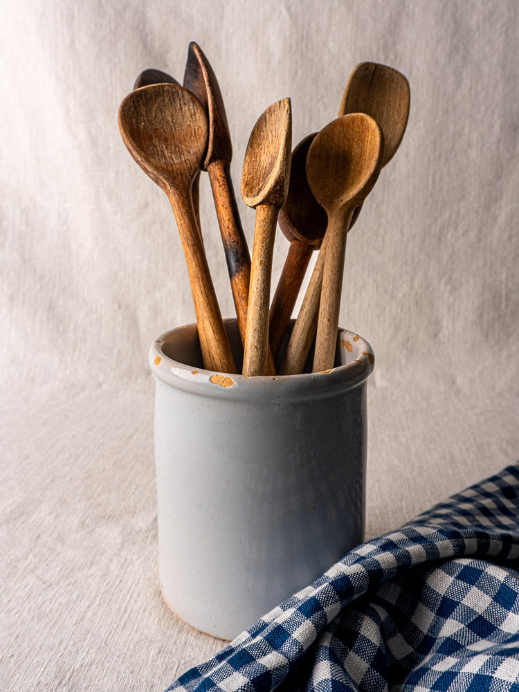 Antique French white glazed earthenware Pot à Rillettes with orange-brown spots on textured surface.