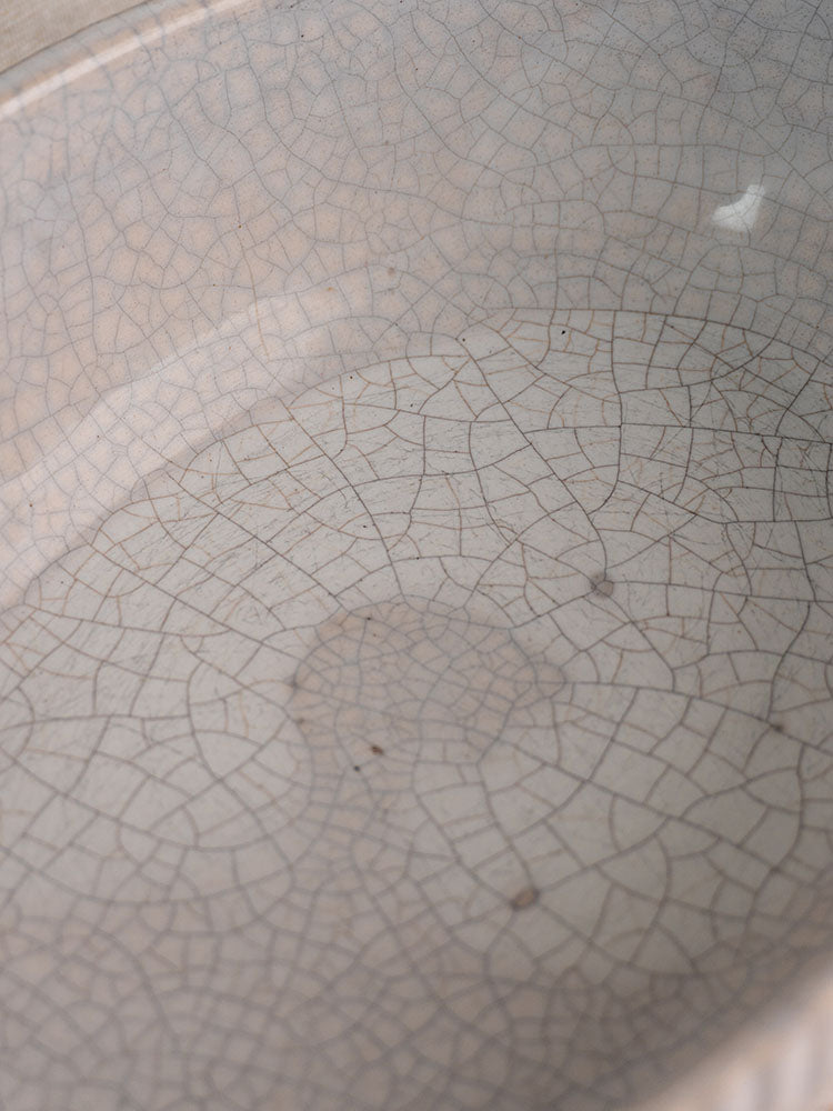 Antique French gratin dish, early 20th century earthenware with light beige crackle glaze and circular indentation.