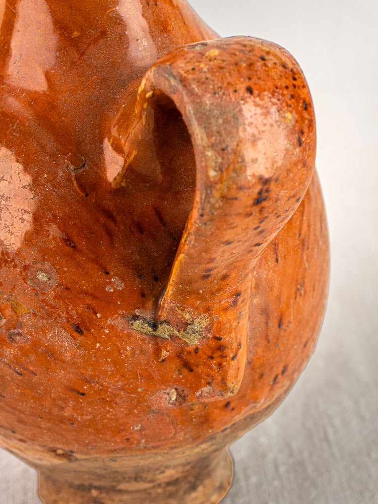 Antique French terracotta wine gourde with twin handles, rustic orange-brown glaze, and surface variations.