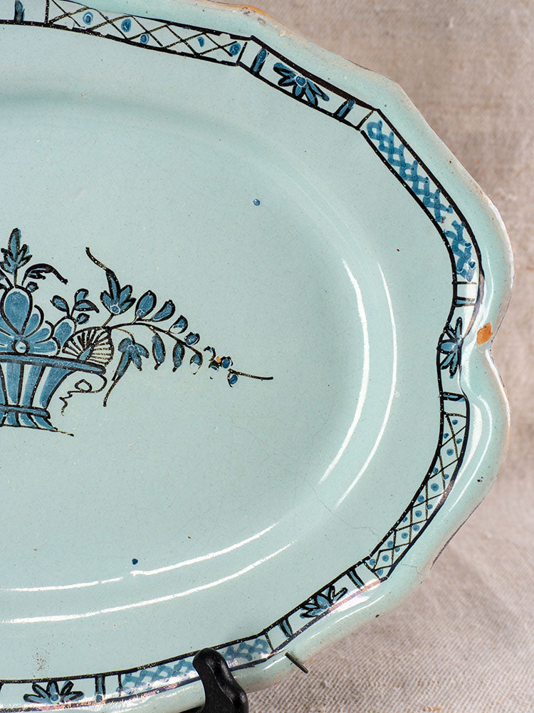 Antique French faience platter, Cul Noir, scalloped rim with chips, black and blue floral center, geometric border.