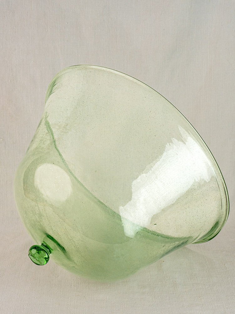 Hand-blown pale green antique French glass garden cloche, 19th century, tipped to reveal its small base knob against a light backdrop.