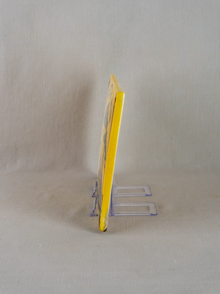 Hand-painted L’Oustalet French faience house plaque with yellow edges on clear display stand.