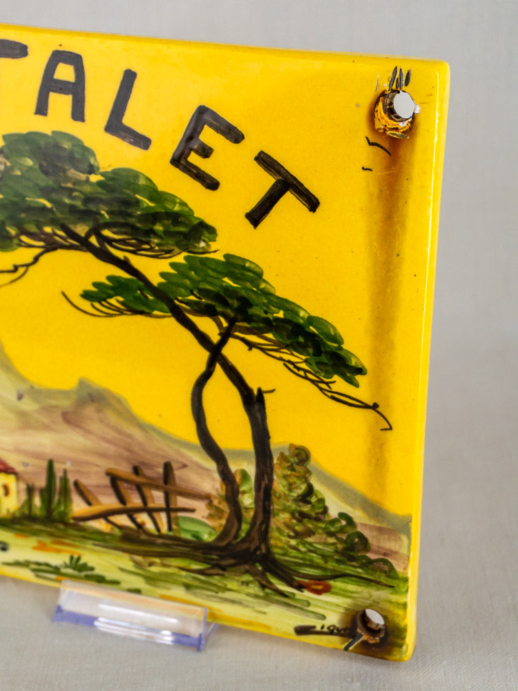 L’Oustalet French faience house plaque with hand-painted Provençal landscape and ‘CHALET’ lettering on yellow ceramic.