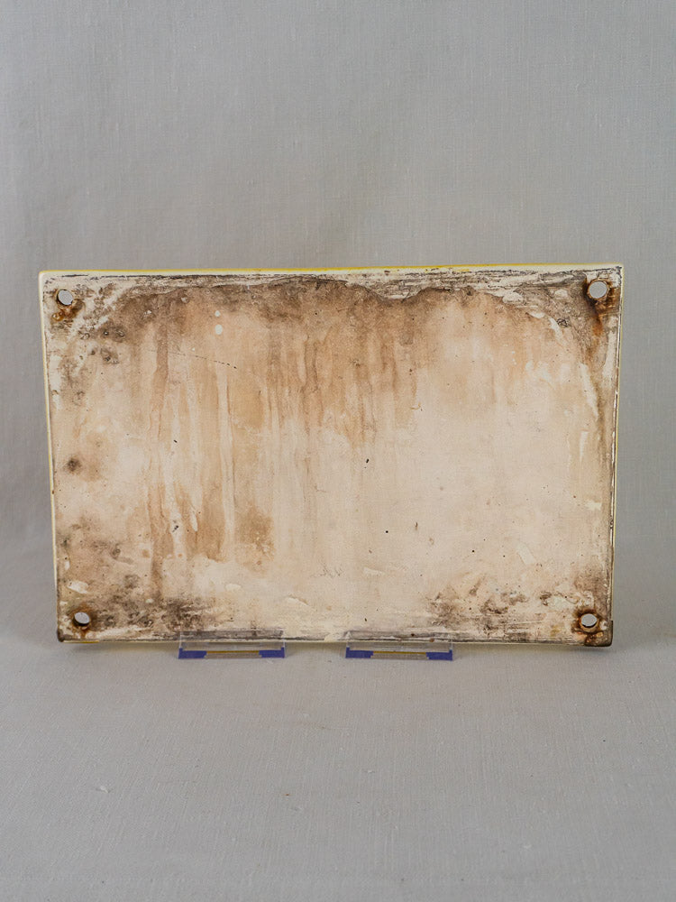 Rectangular French faience house plaque with hand-painted Provençal landscape, weathered and stained, rusted screws in corners.