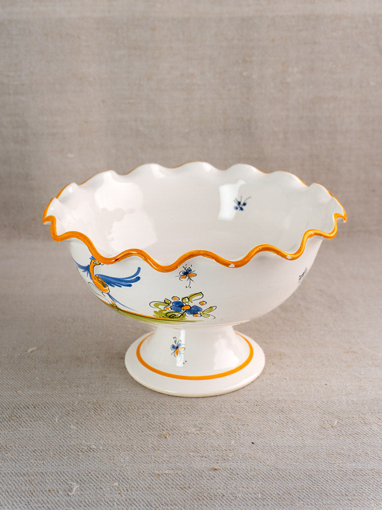 Pair of vintage French Moustiers-style white faience compotes with wavy rims, orange trim, and floral designs.
