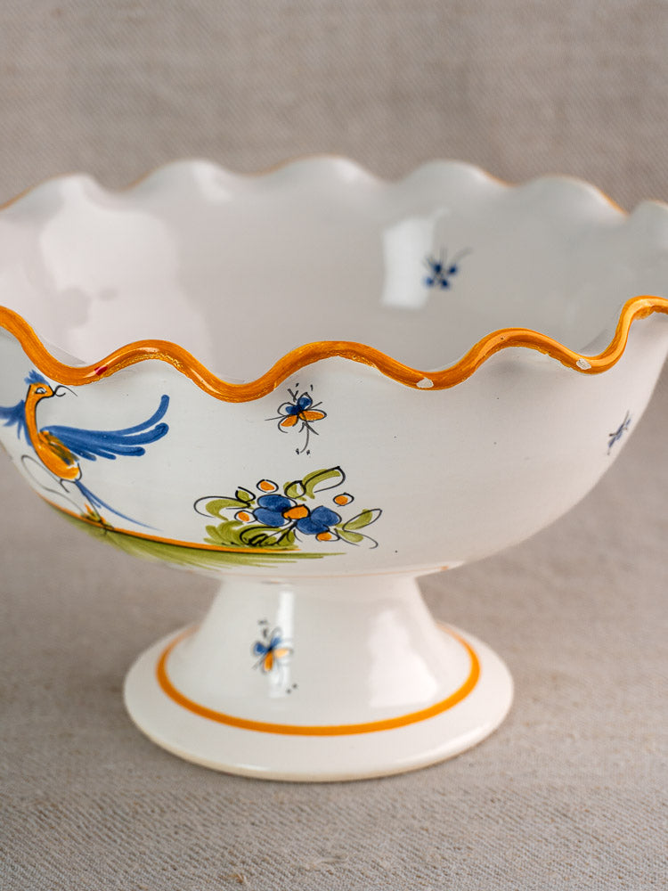 Pair of French Moustiers-style white faience compotes with wavy orange rims and hand-painted bird motifs.