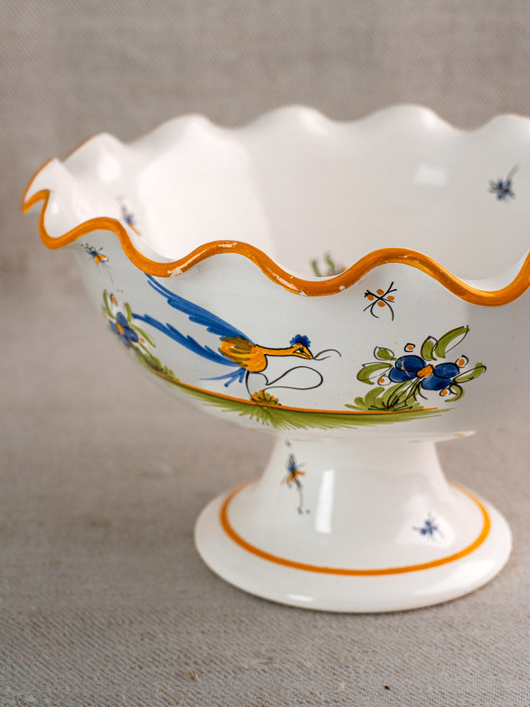 Pair of vintage French Moustiers-style faience compotes with orange scalloped rims and blue bird motifs.