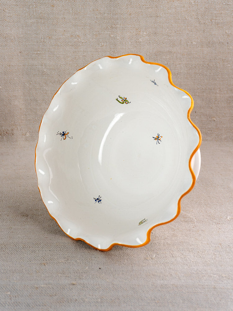 Pair of vintage French Moustiers-style faience compotes with orange rims and colorful insect motifs.