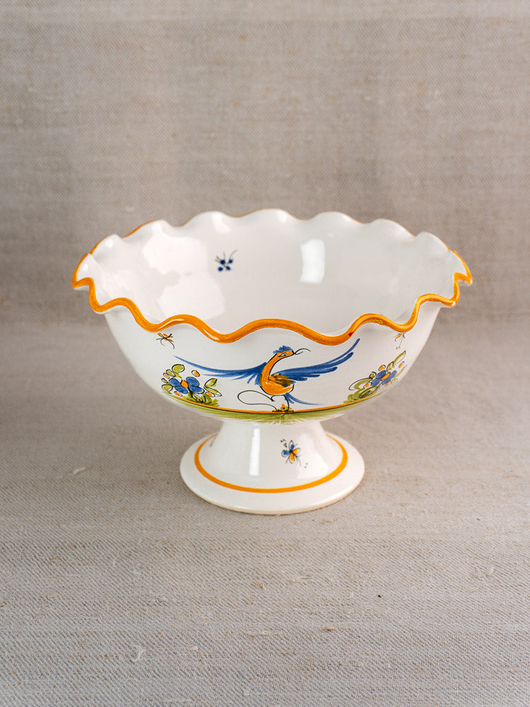 Pair of vintage French Moustiers-style faience compotes with orange scalloped rims, blue birds, and florals.