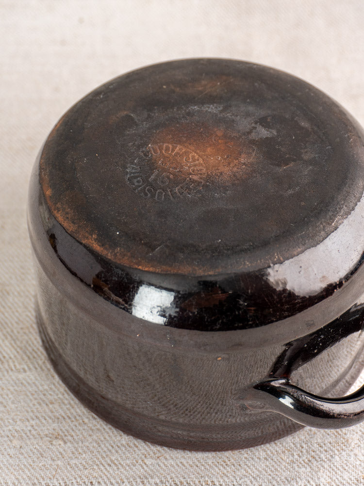 Vintage Albisola glazed earthenware cooking pot, Coop. Stov. mark visible on base, displayed on woven fabric.