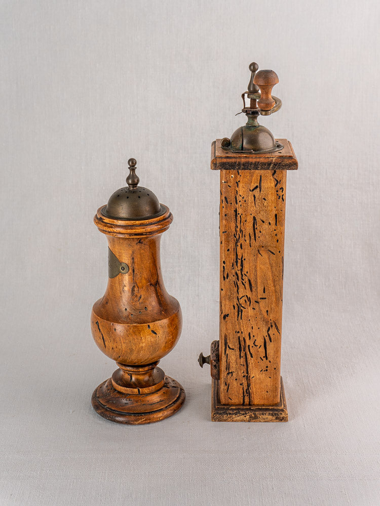 Antique Stefano Ugolini Firenze pepper mill and salt set with classic wormwood motifs, metal tops, side by side.