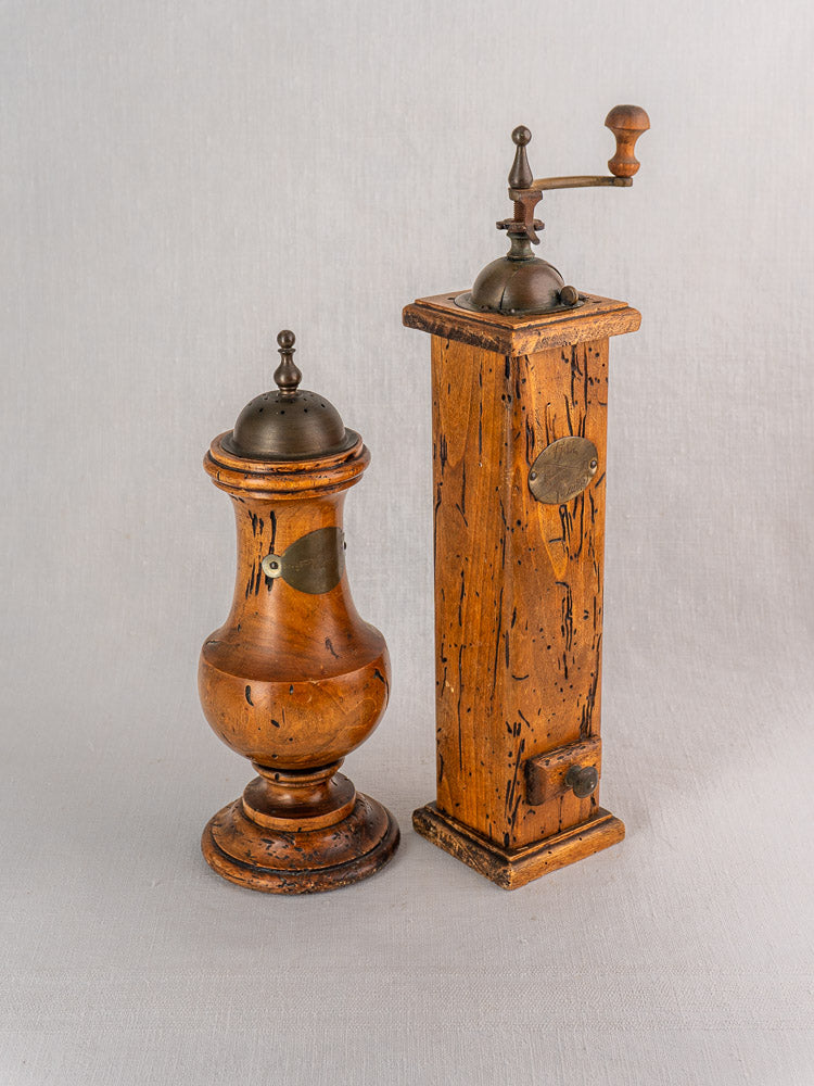 Antique Italian wormwood pepper mill and salt set by Stefano Ugolini Firenze on neutral fabric background.