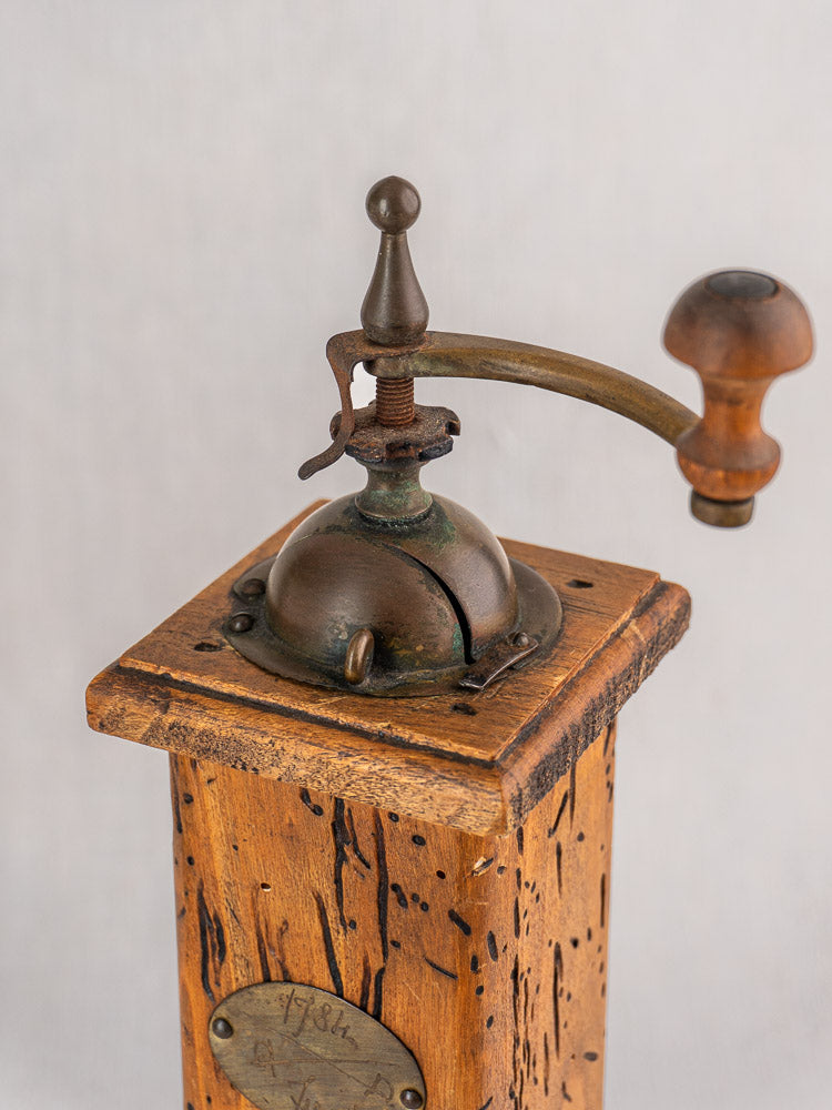 Antique Italian pepper mill and salt set by Stefano Ugolini Firenze with wormwood base, metal dome, and wooden-handled crank.