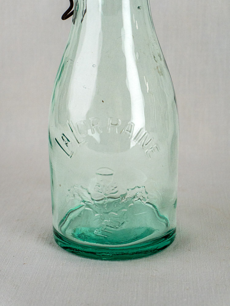 Set of three antique French aqua glass La Lorraine preserving bottles with embossed lettering and crest.