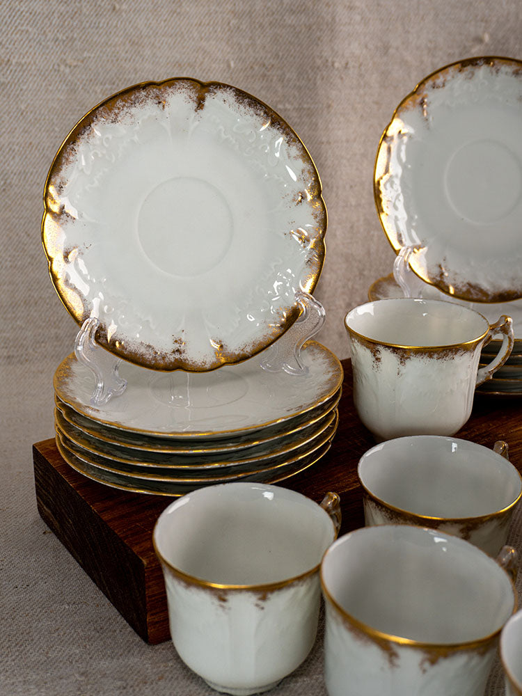 Antique French Limoges demitasse cups and plates by Lafarge & Cie, white porcelain with gold trim.