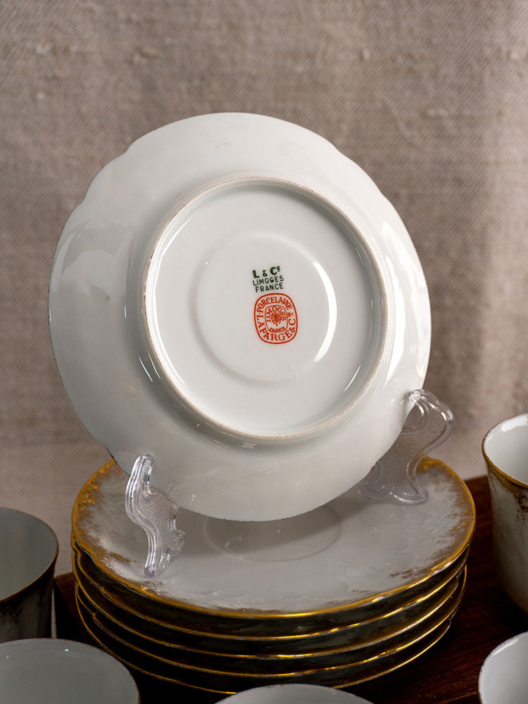 Antique French Limoges demitasse service for 12 with marked porcelain plate and gilt-edged plates.