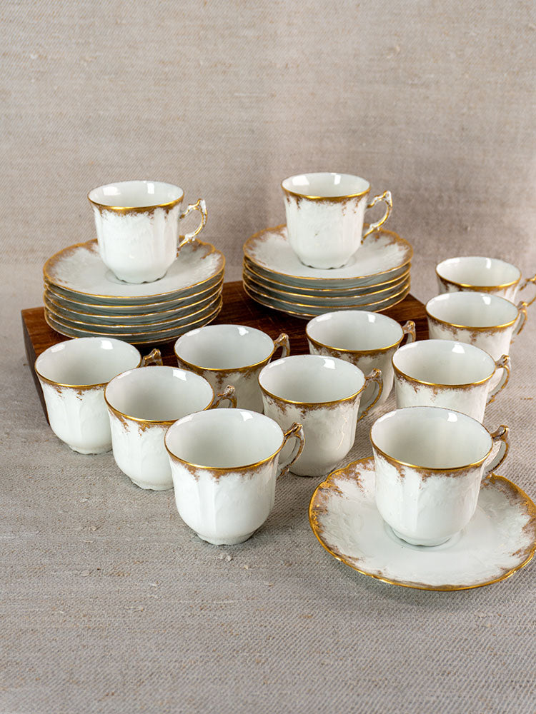 Set of twelve Antique French Limoges porcelain demitasse cups and saucers with gold trim.