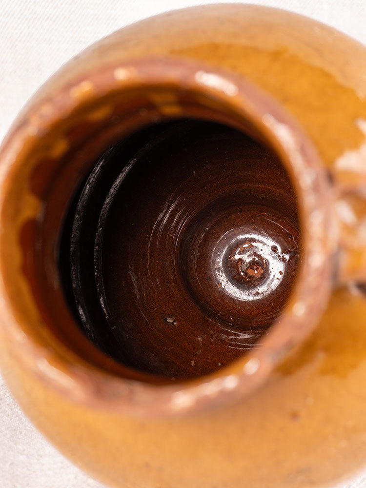 Antique French olive oil jar, late 19th century glazed earthenware, glossy brown, rounded rim and handle.