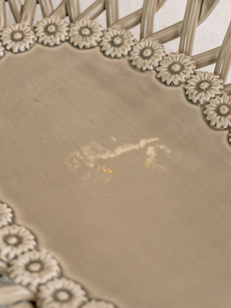 Beige woven chair seat with circular floral motif and central discoloration, reminiscent of Provence faience basket.