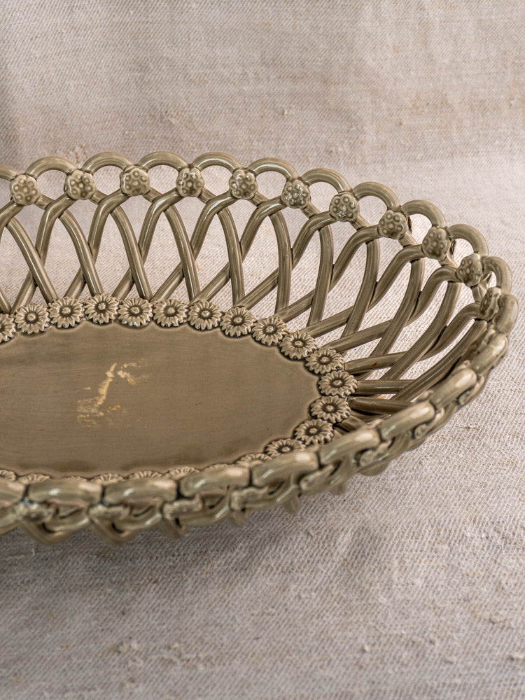 Large vintage Pichon Uzès basket, hand-woven oval ceramic in Provence faience style, on beige textured fabric.