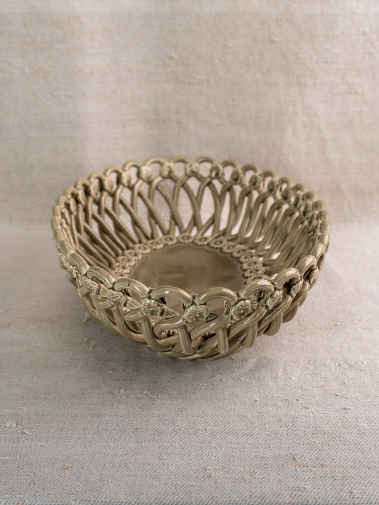 Large vintage Pichon Uzès oval ceramic Provence faience basket on a neutral linen surface.