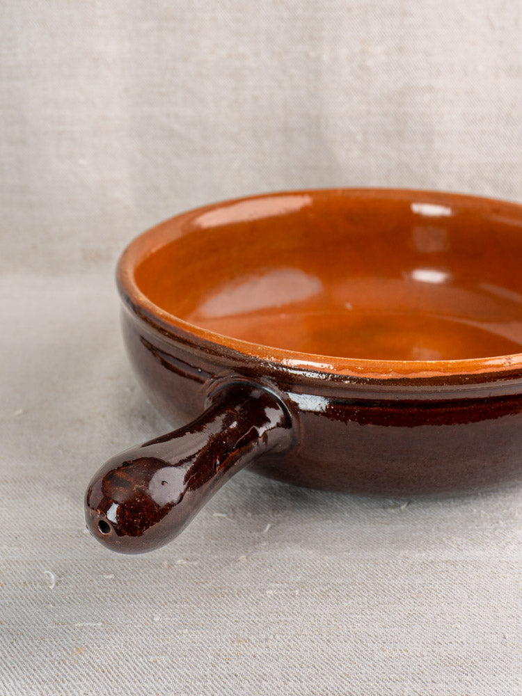 Antique French earthenware poêlon with glossy brown glaze, caramel interior, and single handle for vintage décor or cookware collectors.