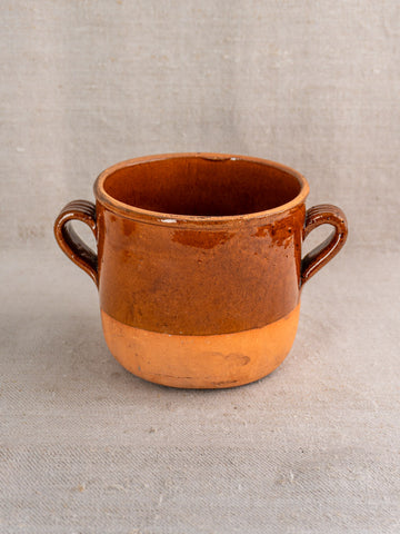 Antique French confit pot in brown glazed earthenware with two side handles and a matte lower section.