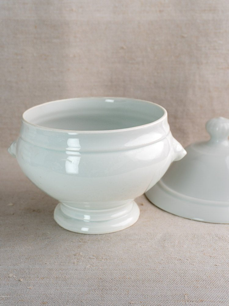 Vintage French CNP white ceramic soup tureen with handles and lid, set with twelve lion head bowls.