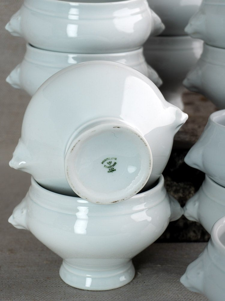 Vintage French CNP lion head soup bowls, closely grouped, one inverted showing green maker’s mark.