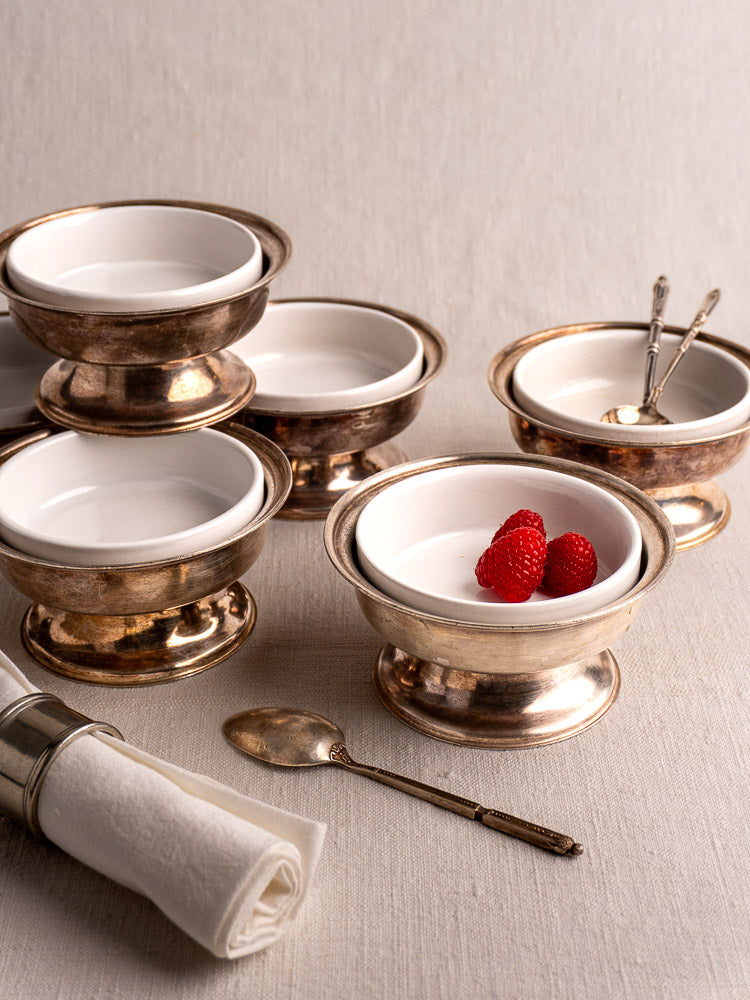 Set of six vintage Italian Sambonet silver-plated dessert coupes with white porcelain inserts.