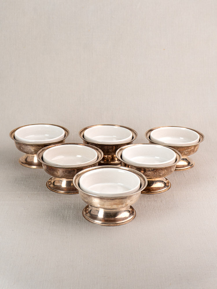 Set of six vintage Italian Sambonet silver-plated dessert coupes with white porcelain inserts.