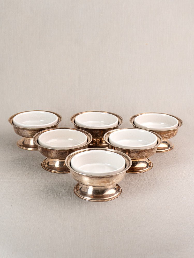 Set of six vintage Italian Sambonet silver-plated dessert coupes with white porcelain inserts.