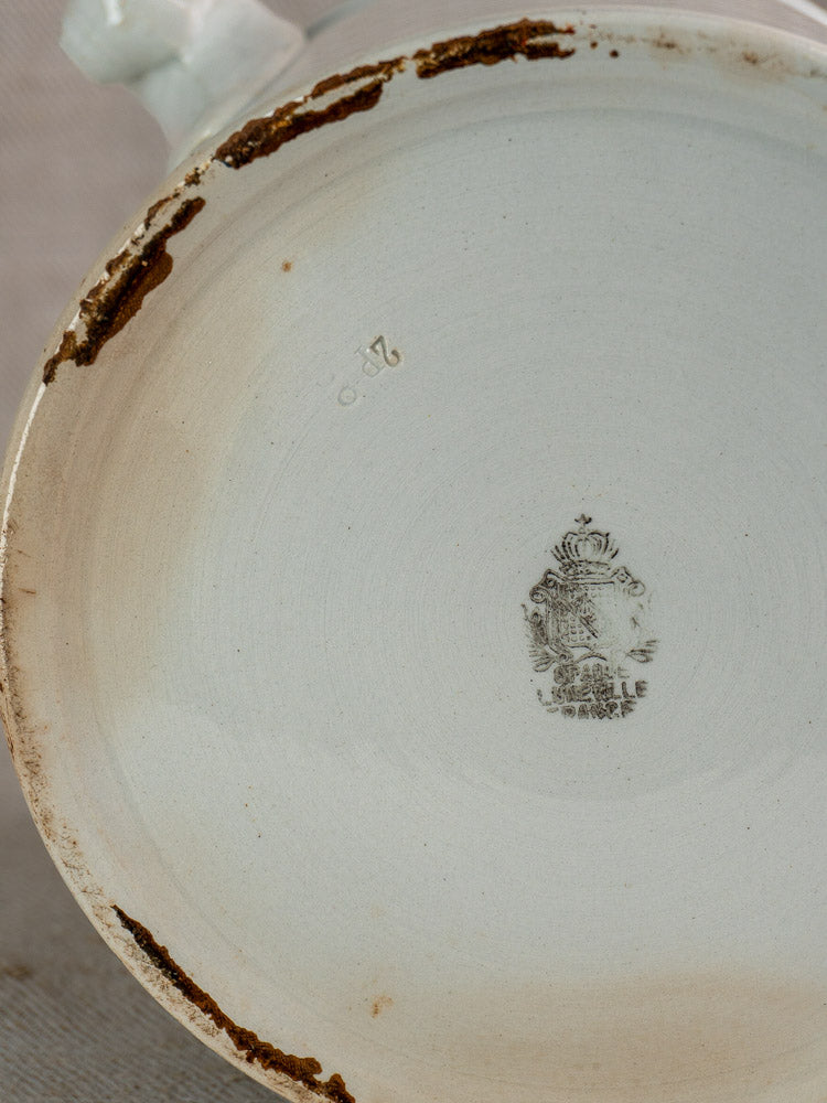 Antique French Lunéville white faience soup tureen bottom with rust discoloration and faded black crowned maker’s mark.