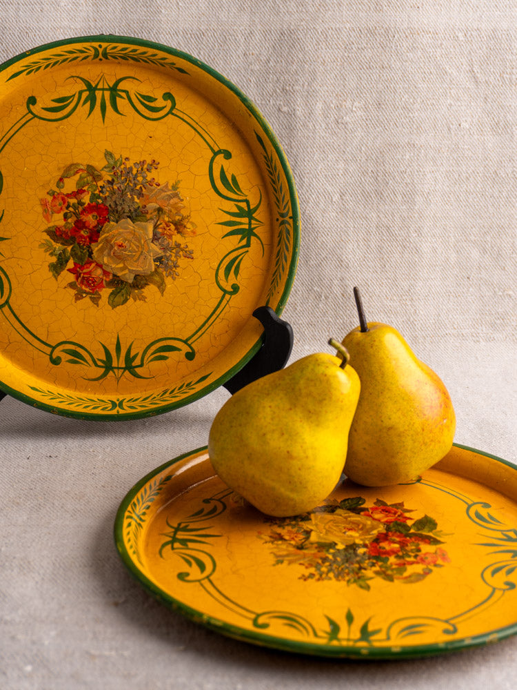 Antique French painted tôle tray with yellow floral design, matched pair shown on neutral fabric.