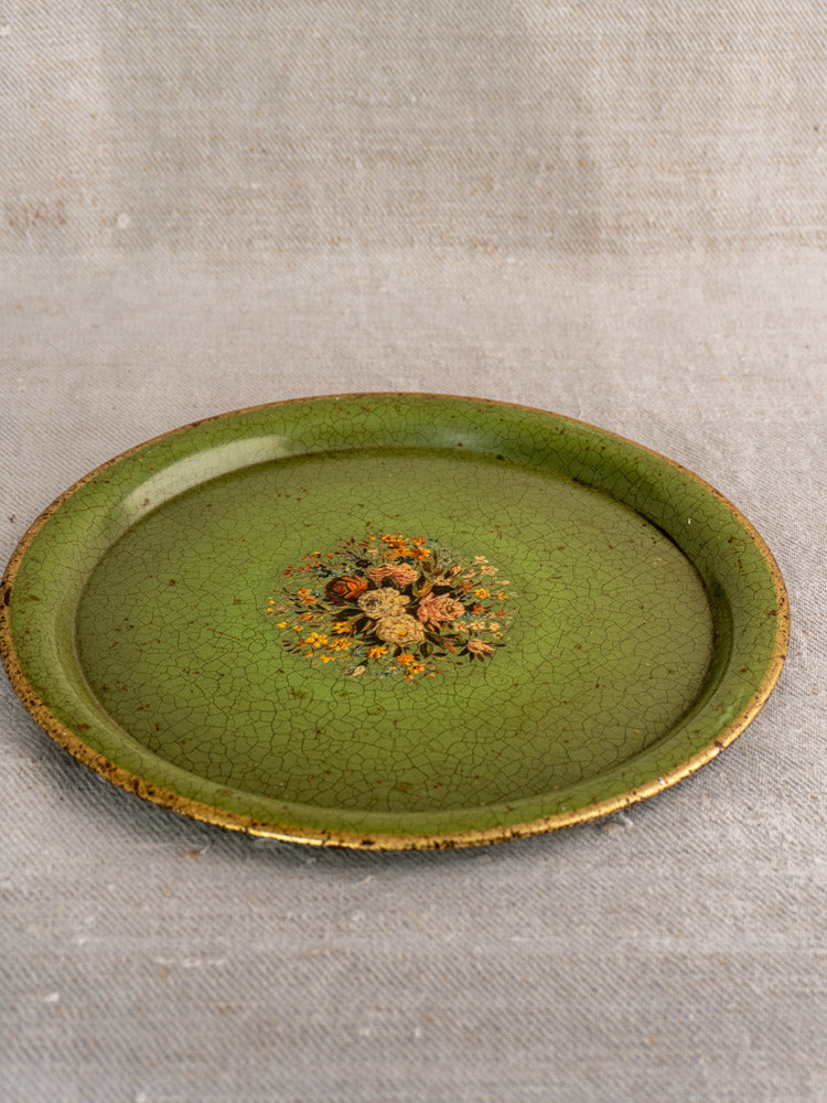 Antique French painted tôle tray, round with green crackled finish, gold rim, and floral center motif.