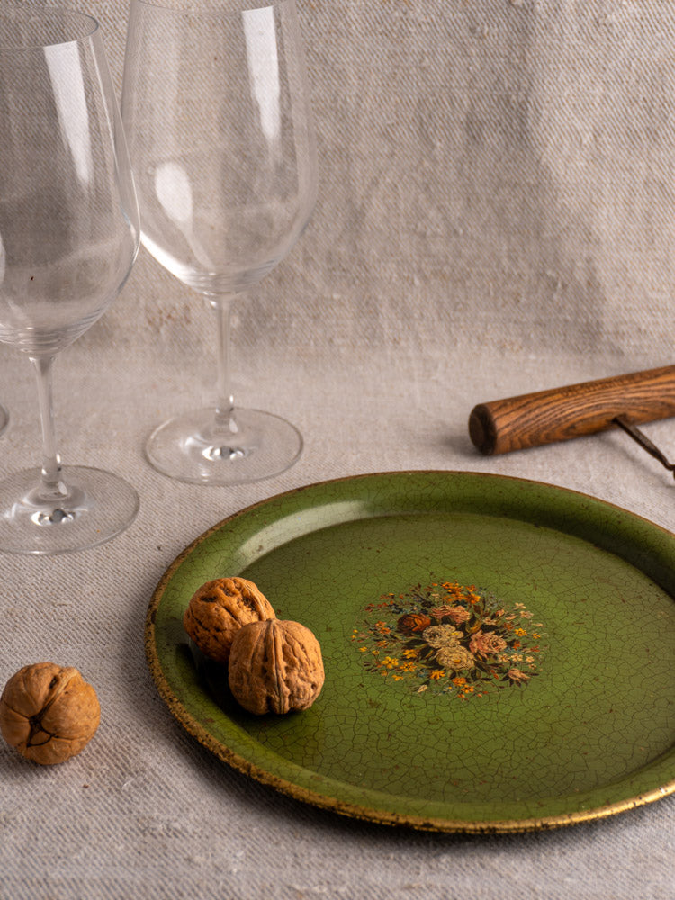 Pair of antique French painted tôle trays c.1900 with green floral motif, walnuts, wine glasses, nutcracker.