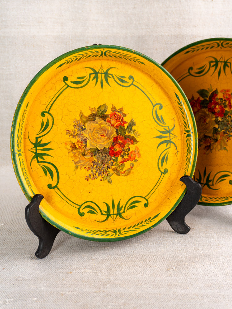 Antique French round yellow painted tôle tray with green accents and central floral motif, c. 1900.