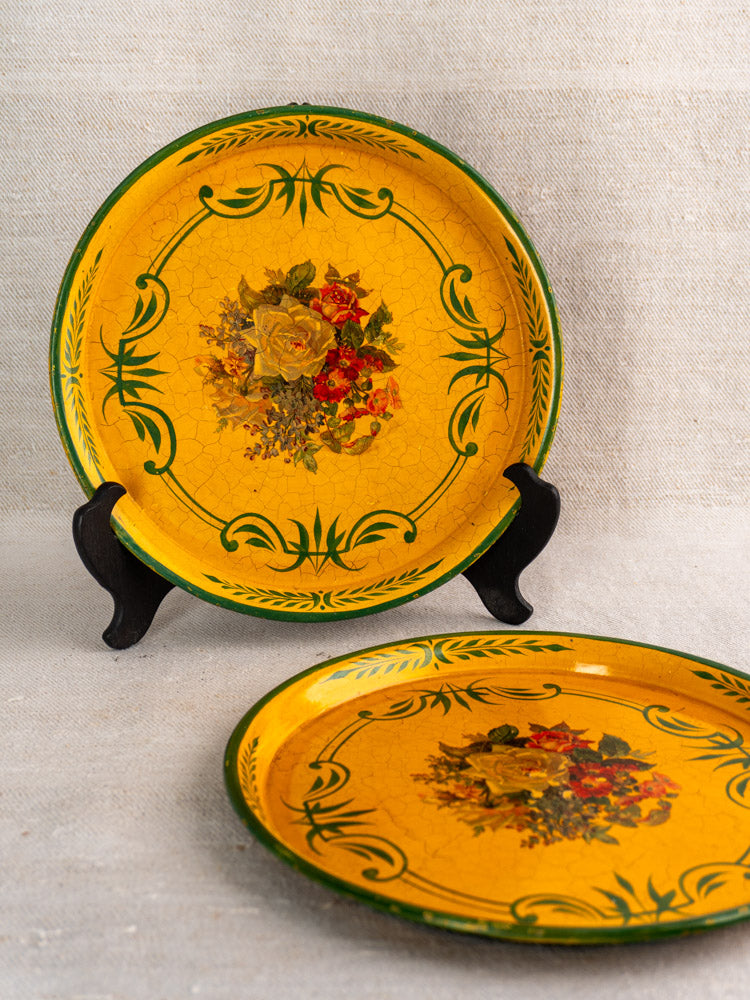 Antique French painted tôle trays, circa 1900, yellow with green borders and floral designs.