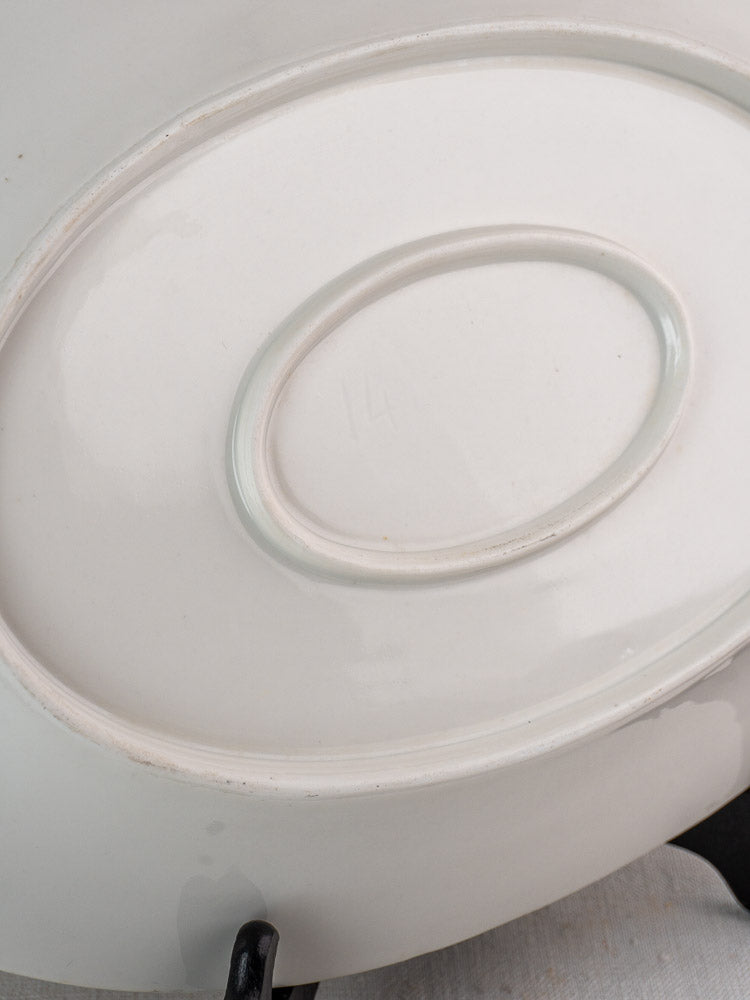 Antique French white ironstone oval platter underside with central indentation and faint embossed number 14.