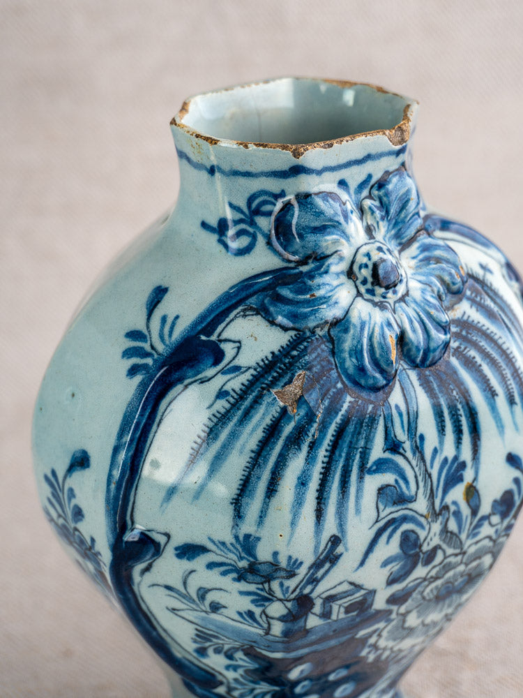 Antique Dutch Delft vase pair, circa 1700, blue and white floral motifs, chipped rim and wear, on a neutral fabric background.