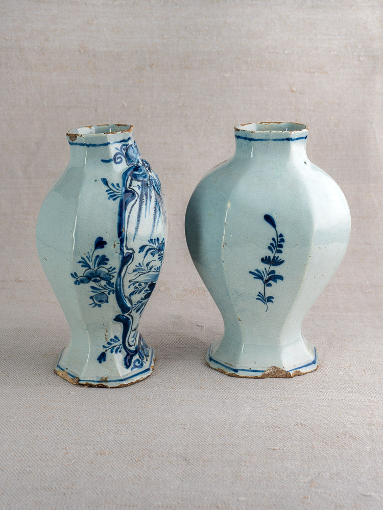 Antique Dutch Delft vases, circa 1700, blue and white with floral motifs, hexagonal bodies, chipped rims and bases.
