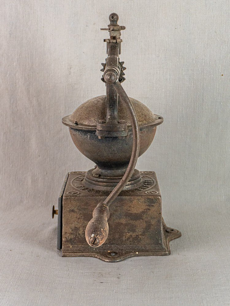 Antique French cast iron Peugeot Frères coffee mill, circa 1900, with round top and crank handle.