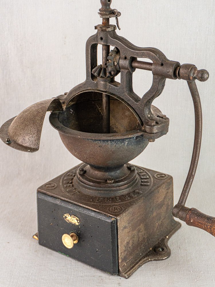 Antique French Peugeot Frères cast iron coffee mill with hand crank and drawer, circa 1900.